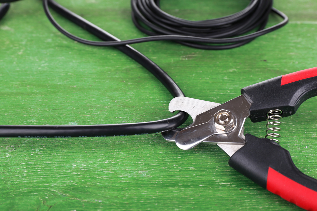Cutters Cut Cable on Wooden Background