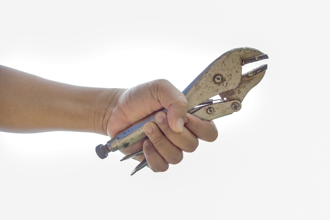 A hand holding locking grip pliers on white background.